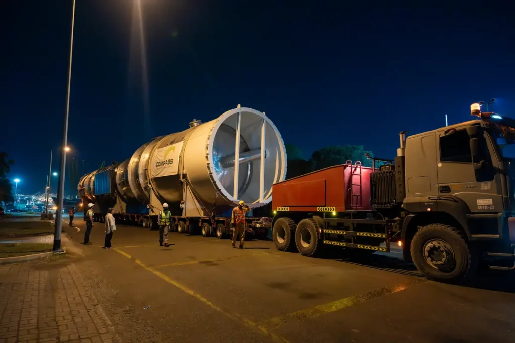 130-tonne stripper column on SPMT trailers at night