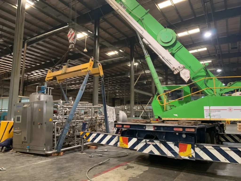 Crane lifting equipment inside a factory warehouse